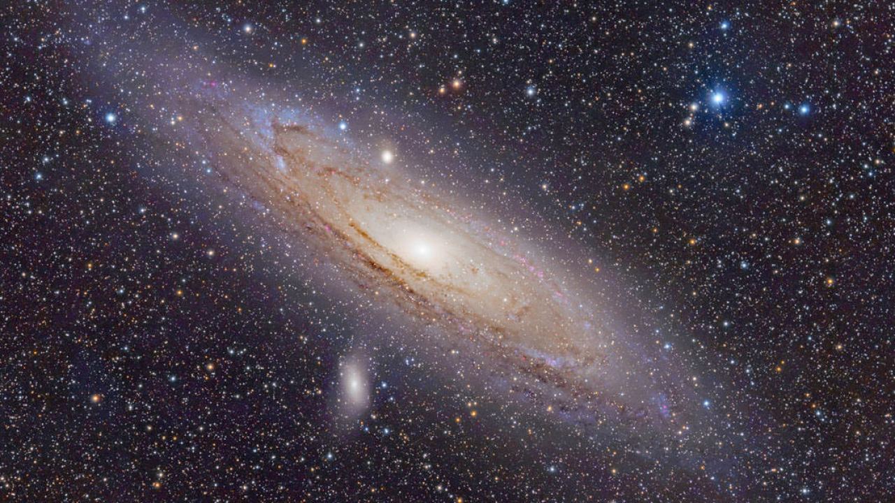 Andromeda galaxy swallowing dwarf galaxies