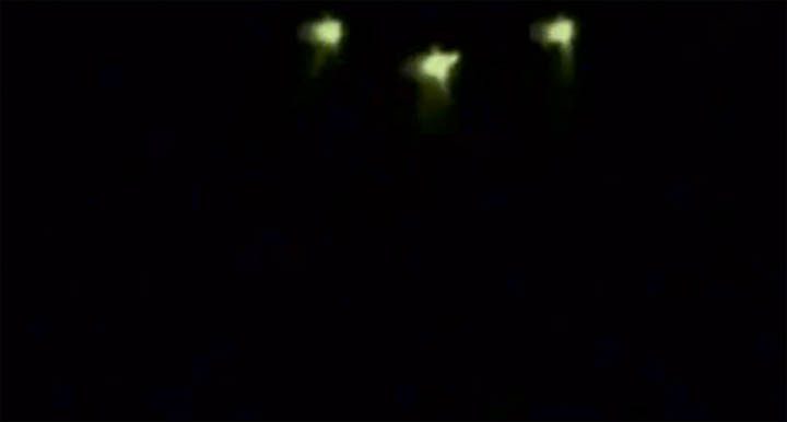 Nikita Tomin captured this image of a UFO flying over a lakeside resort in the Irkutsk region, with three green-hued lights.