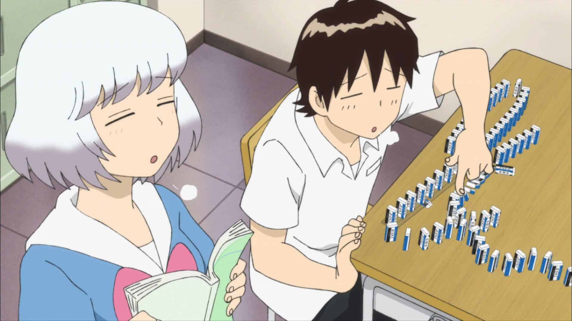a boy playing with domino and a girl reading a book