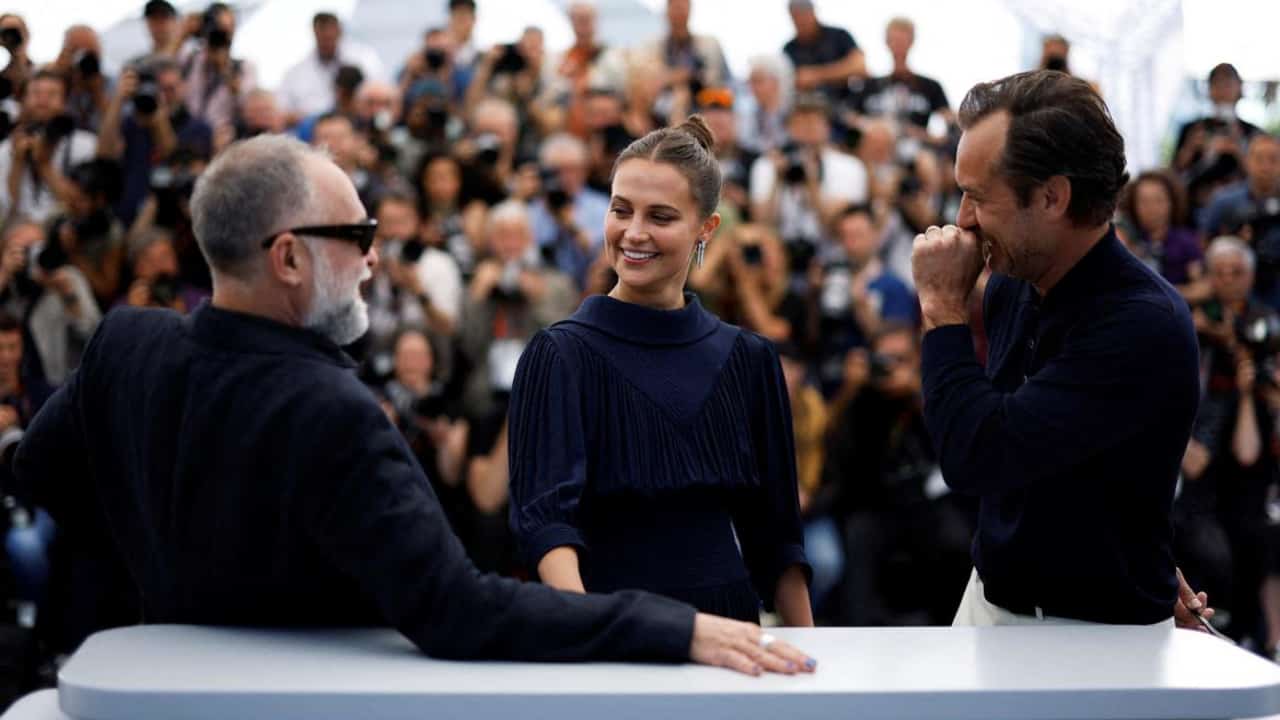 Karim Ainouz, Alicia Vikander and Jude Law at Cannes 2023