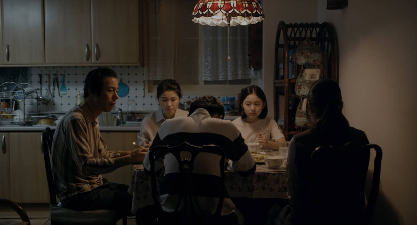 A family sitting around a dining table
