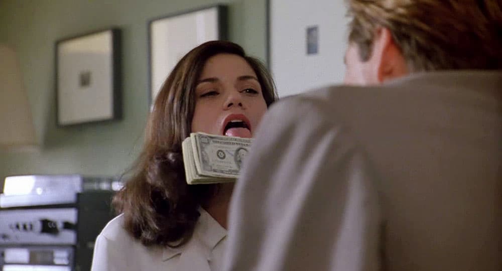 A woman, licking a bundle of notes, mockingly