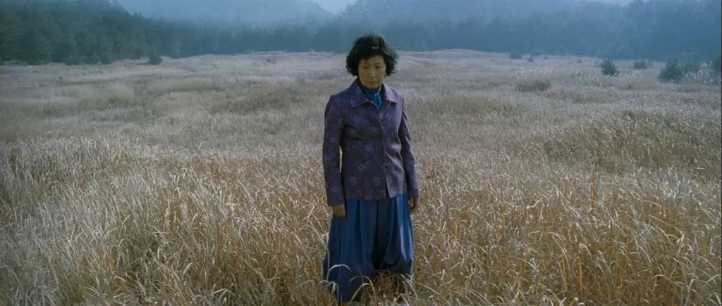Titular character from the movie Mother standing in an open field