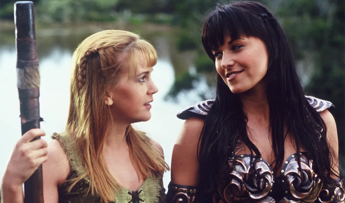 Lucy Lawless and Renee O'Connor in the show, Xena Warrior Princess (Credits: Vanity Fair)