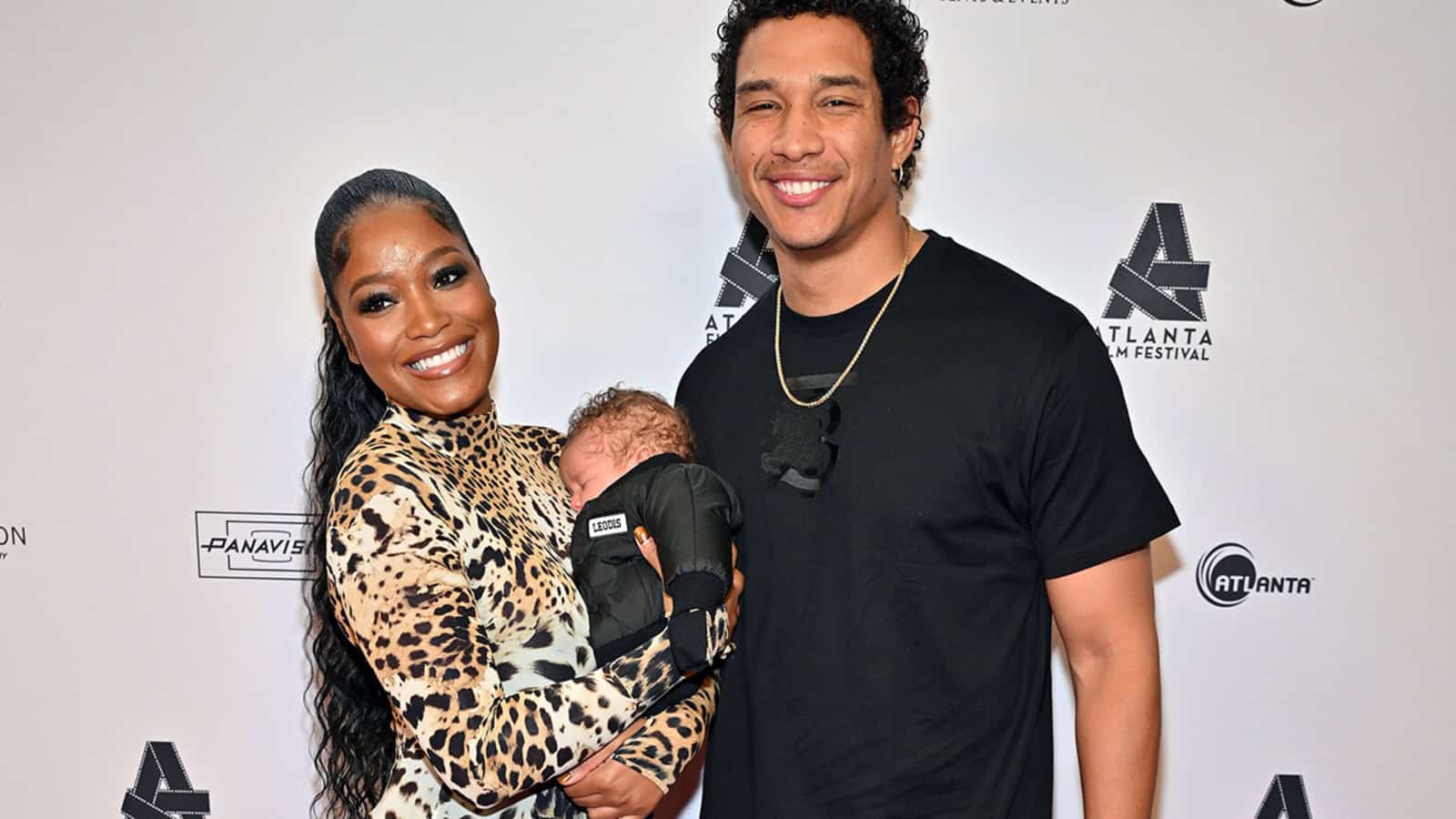Darius and Keke at a red carpet event with their new born baby.