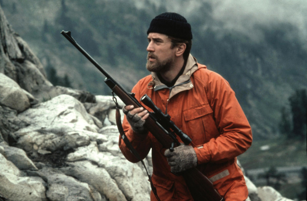 Mike killing a deer on their hunting trips in the film, The Deer Hunter (Credits: Universal Pictures)
