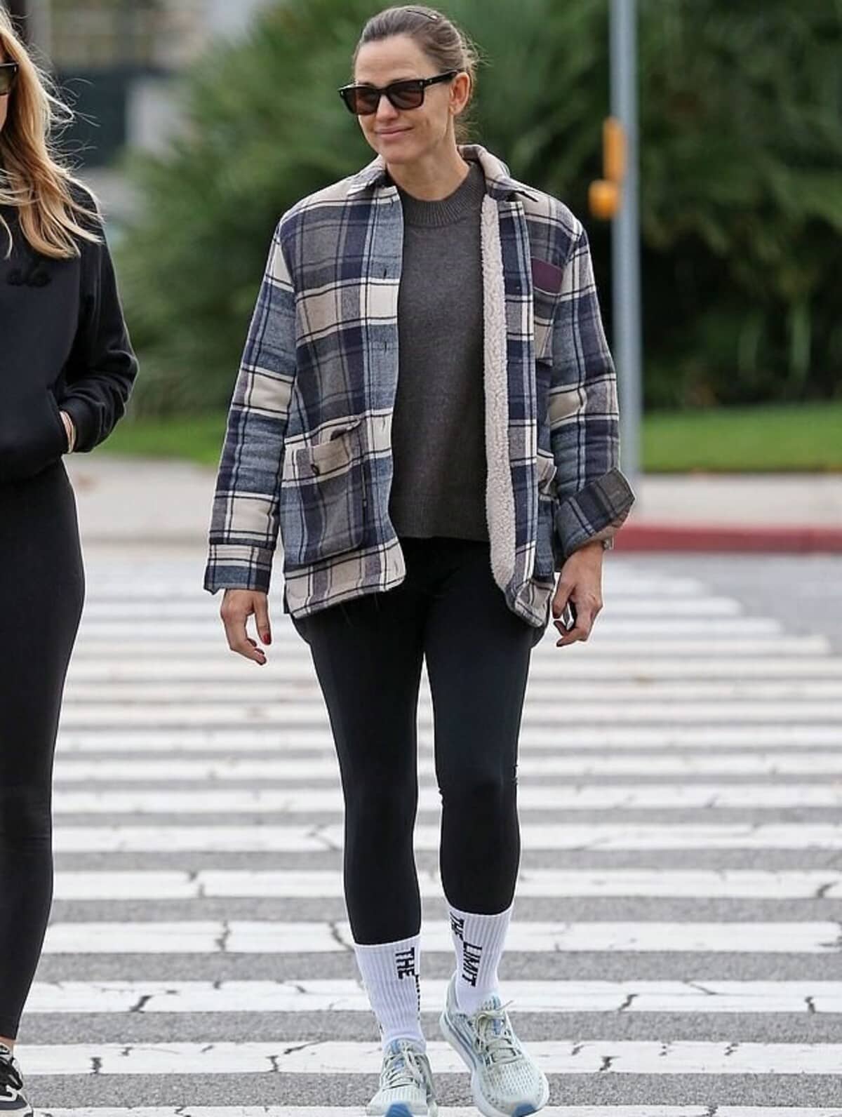 Jennifer Garner models a plaid jacket over workout clothes.