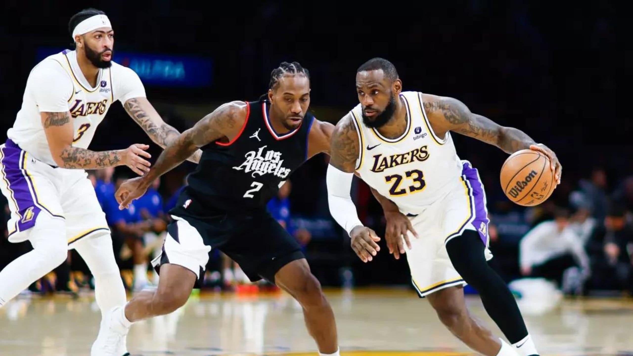 Lakers star LeBron James driving past Clippers' Kawhi Leonard