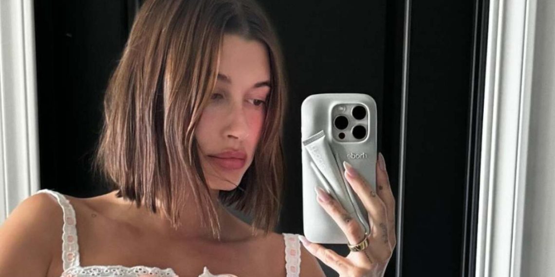 Hailey Bieber flaunts her Rhode lip phone case by taking a mirror selfie (Credit: haileybieber/Instagram)