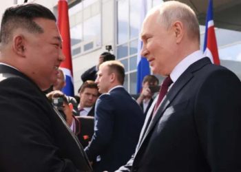 Vladimir Putin and Kim Jong Un shaking hands of each other (Credit: Reuters)