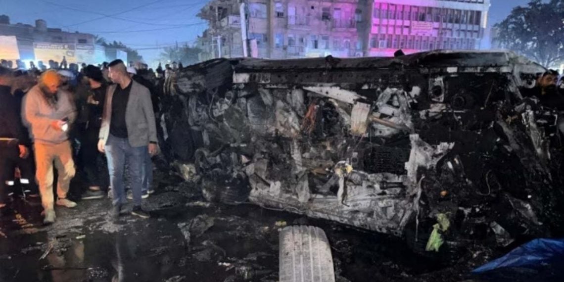 Several people inspecting a vehicle after what securities shared was a deadly drone strike (Credit: YouTube)