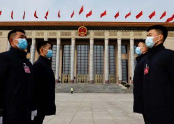 Security personnel stand guard, on the day of the opening session of the Chinese People's Political Consultative Conference, held in China (Credit: Reuters)