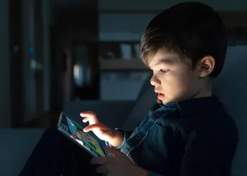 young boy using a digital tablet (Image via Getty)