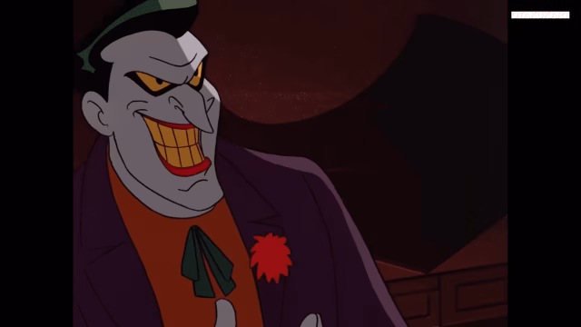 Joker smiles with his signature grin while wearing a purple suit