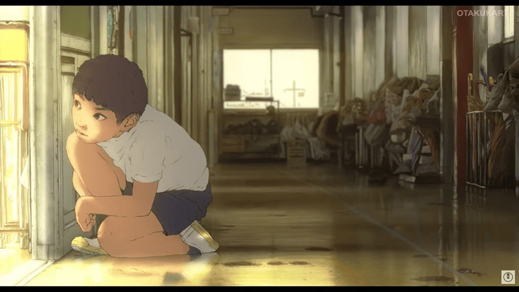 Young Tsubasa crouches in a quiet school hallway in a scene from the upcoming anime film