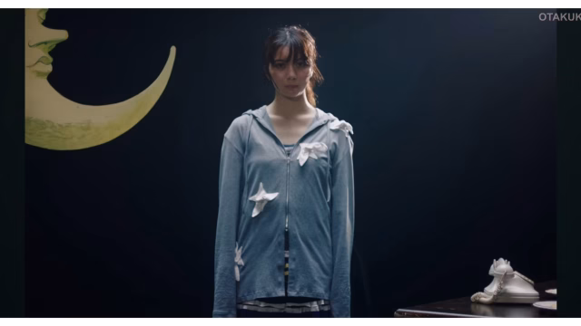 Moka Kamishiraishi stands in a scene from the official Wanna me music video for Ascendance of a Bookworm: Adopted Daughter of an Archduke.