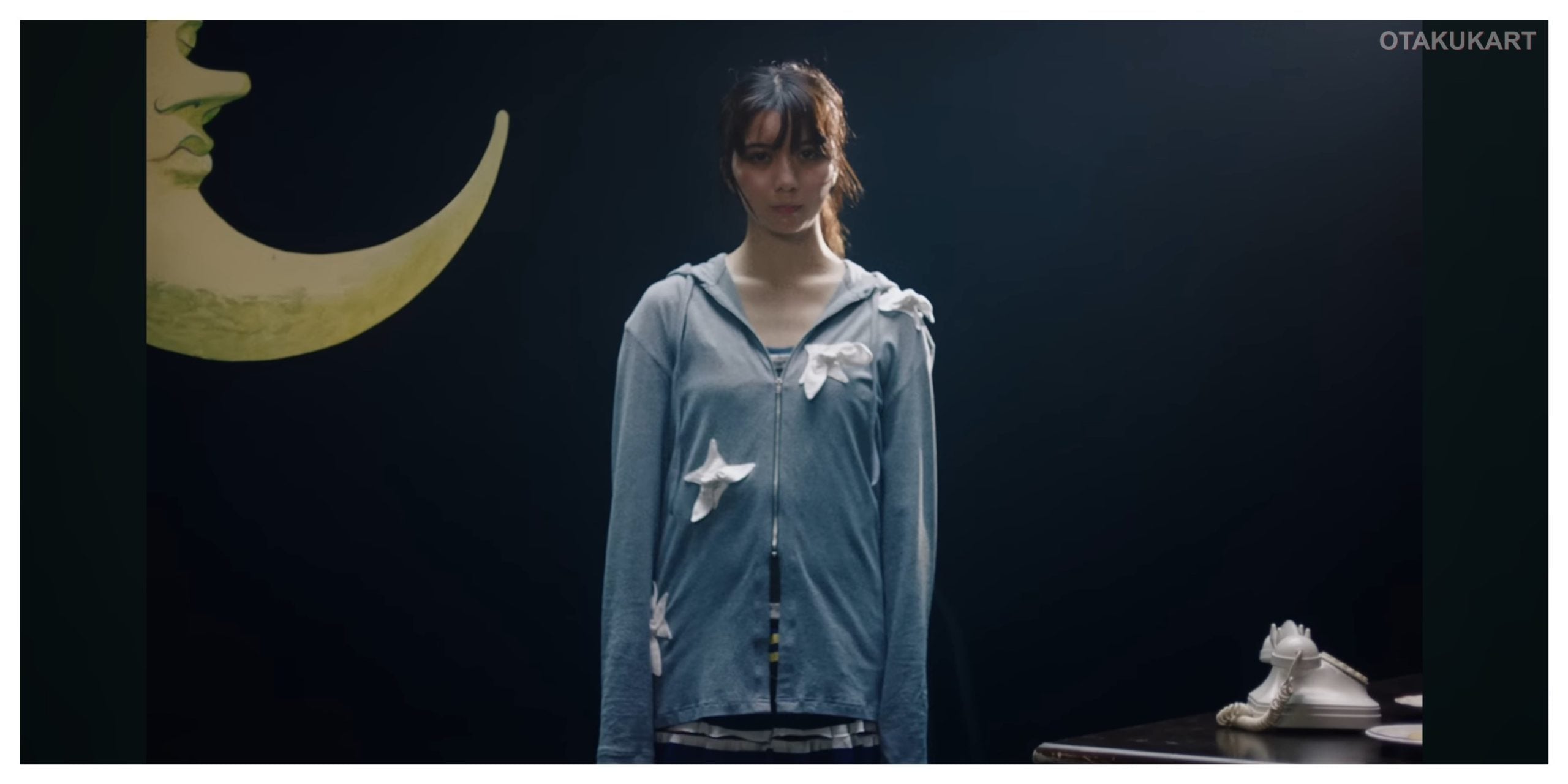 Moka Kamishiraishi stands in a scene from the official Wanna me music video for Ascendance of a Bookworm: Adopted Daughter of an Archduke.