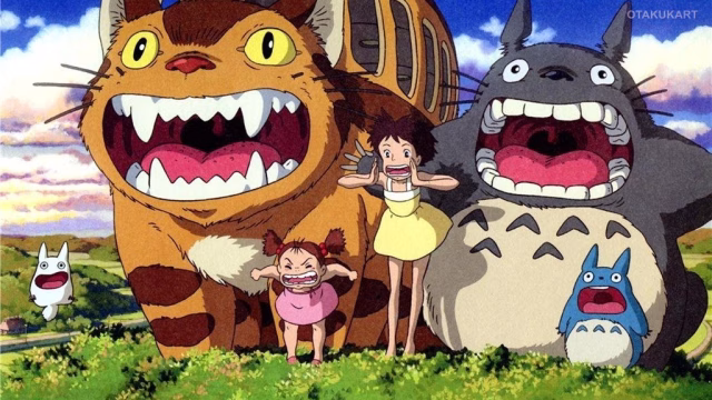 My Neighbor Totoro characters shouting happily with Catbus, Satsuki, Mei, and forest spirits in a sunny meadow.