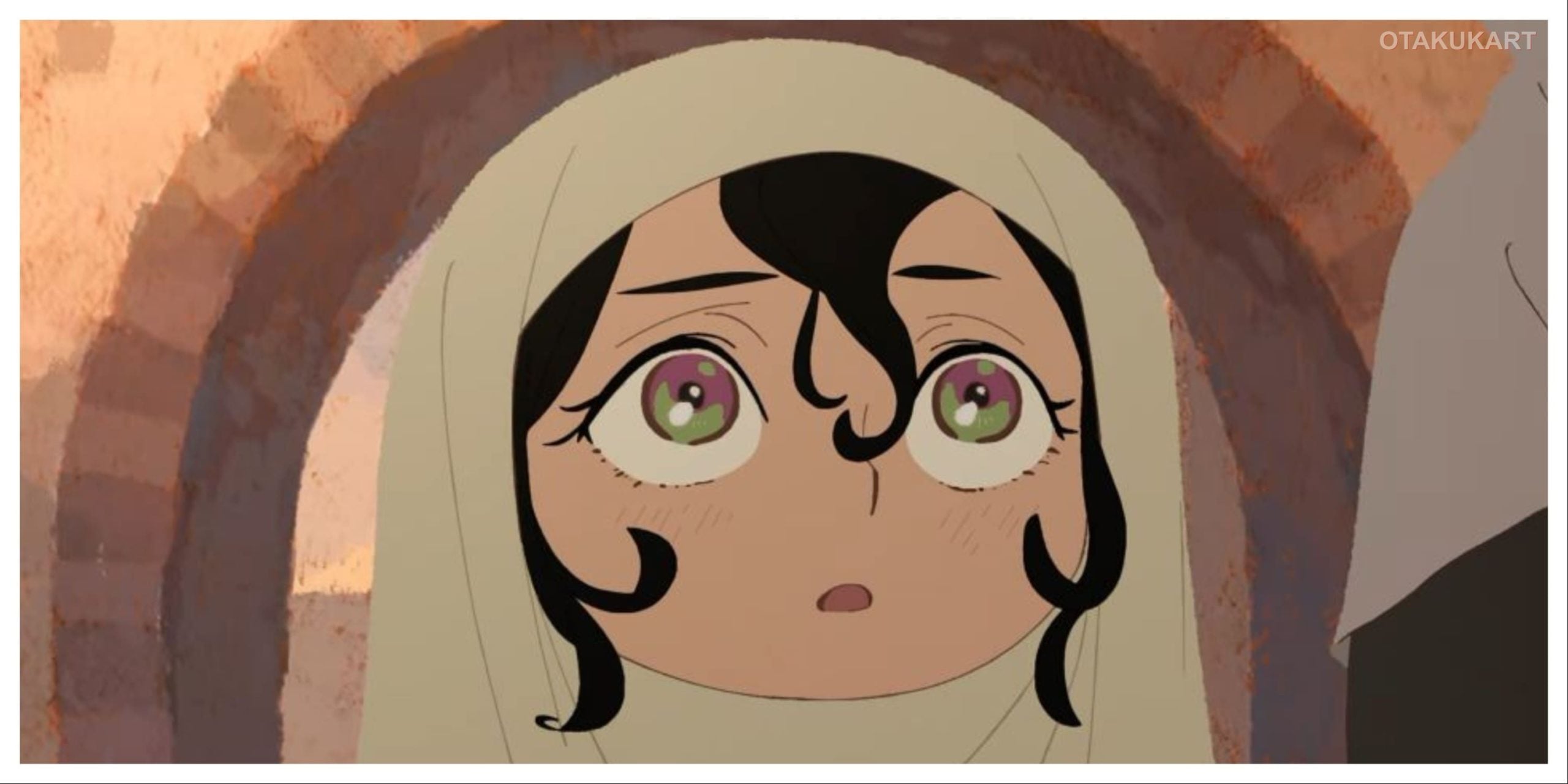 atima looks up with a surprised expression while wearing a hooded cloak in Jaadugar: A Witch in Mongolia.