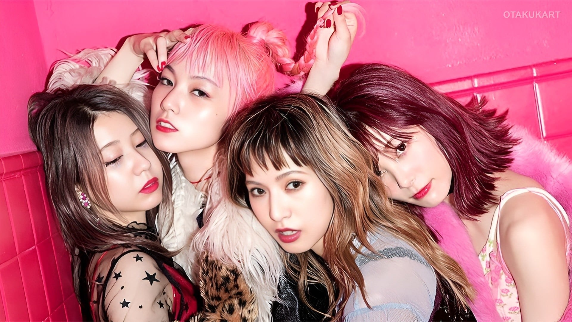 Japanese rock band SCANDAL posing with their instruments in coordinated outfits.